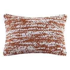 a brown and white pillow on a white background