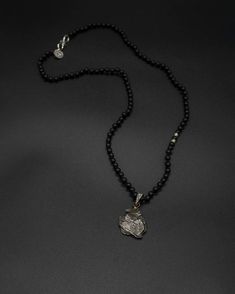 Add a touch of cosmic beauty to your collection with this Campo del Cielo meteorite pendant on a hand-knotted onyx and silver accented chain. The onyx chain is 59 cm long [app 23 in long] Black Amulet Necklace With Polished Beads, Black Amulet Necklaces With Polished Beads, Black Amulet Style Necklaces With Polished Beads, Silver Obsidian Pendant Necklace, Silver Obsidian Jewelry With Gemstone Beads, Silver Obsidian Gemstone Necklace, Spiritual Silver Obsidian Necklace, Black Amulet Necklace With Large Pendant, Black Amulet Necklace With Natural Stones