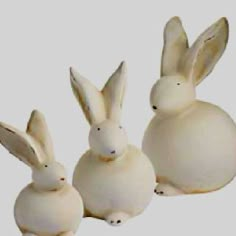 three white rabbits sitting next to each other