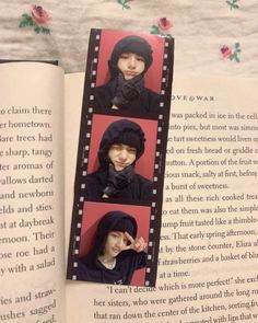 an open book with pictures of people in black clothes and hats on the pages, next to a pink rose