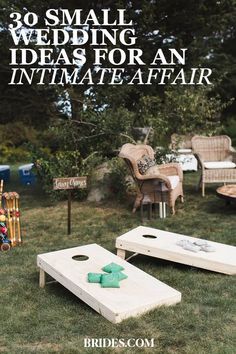 an outdoor wedding game set up in the grass with lawn furniture and chairs around it