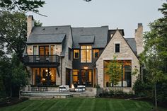 a large house with lots of windows on the front and side of it's facade