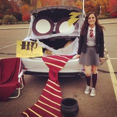 a woman standing in front of a car with a harry potter costume on