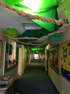 the hallway is decorated with green and white paper streamers that hang from the ceiling