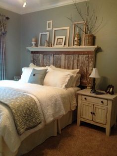 a bedroom with a bed, nightstand and pictures on the wall above it's headboard