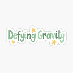 the words defying gravity are written in green and yellow stars