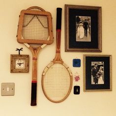 a tennis racket is hanging on the wall with pictures and other items around it