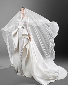 a woman in a white wedding gown and veil