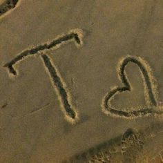 the word ti is written in the sand