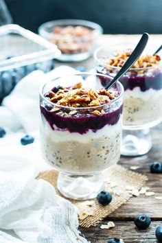 two glasses filled with yogurt and blueberries