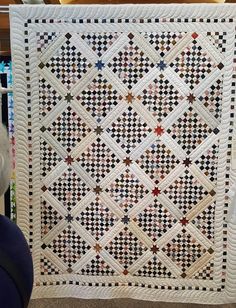 a quilted wall hanging in a store