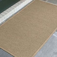 a brown door mat sitting on the side of a building