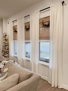 a living room filled with furniture and christmas decorations