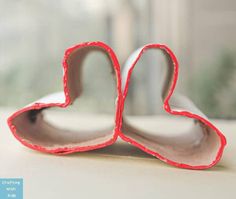 two heart shaped cookie cutters sitting on top of a table