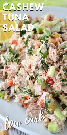 tuna salad on a white plate with lemon wedges