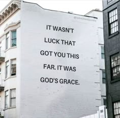 a large sign on the side of a building that says it was not luck that got you this far, it was god's grace