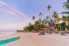 the beach is lined with chairs and umbrellas