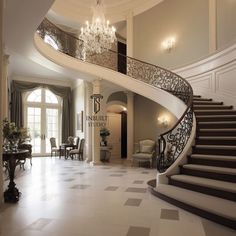 a large foyer with chandelier and stairs leading up to the dining room area