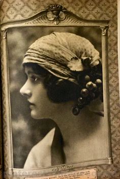 an old photo of a woman wearing a turban