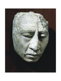 a sculpture of a man's head with his eyes closed