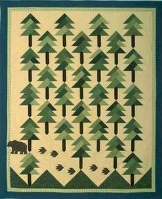 a quilt with trees and a bear on it