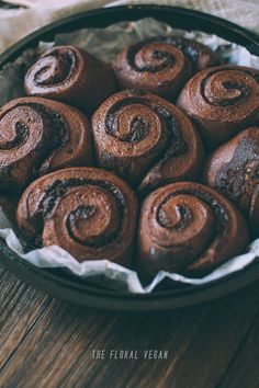 chocolate cinnamon rolls in a pan on a wooden table