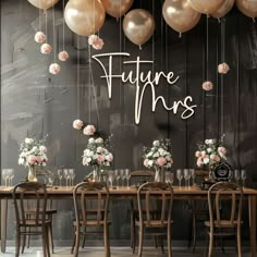 there is a table with many balloons and flowers on the wall next to it that says future mrs