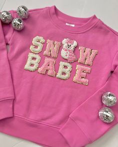 "Girls \"SN⛄️W  BABE\" Chenille Patch Sweatshirt. This top is absolutely adorable! Stylish--fun and perfect for the holidays! These also make the BEST gifts.  ⛄️ ☃️  🤍💕 ❄️  sweatshirt color: Pink with Pink + white chenille lettering--and the cutest chenille snowman patch for the perfect accent!  here's how to order: 1. Select your top size in the drop down menu.  2.  Click Add to Cart, then go back and repeat for each top. SIZING: * Sweatshirts are a classic fit. Please refer to size chart in listing photos for details. Want to see even more? Or grab the Christmas Sunnies to match-- Check out my FULL Shop! www.eyecandyandfluff.etsy.com   CAREPat any spots out with a cloth *Avoid the washer *Always air dry *Do not dry clean  Seller is not responsible for customers not following care instr Pink Long Sleeve Tops For Festive Occasions, Pink Long Sleeve Festive Tops, Festive Pink Crew Neck Top, Pink Letter Print Top For Winter, Cute Long Sleeve Tops For Festive Occasions, Pink Festive Winter Top, Winter Pink Top With Letter Print, Pink Tops With Letter Print For Winter, Cute Crew Neck Top With Glitter Print