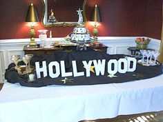 the hollywood sign is on display in front of a table with candles and other decorations