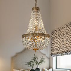 a chandelier hanging from the ceiling in a bedroom