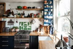 a kitchen filled with lots of clutter and cooking utensils on top of wooden counter tops