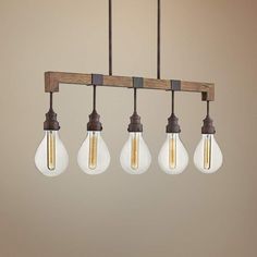 five light bulbs hanging from a wooden beam in an industrial - style lighting fixture with wood and glass shades