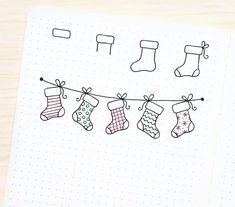 an open notebook with christmas stockings hanging on a line