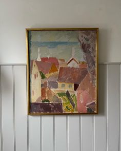 a painting hanging on the wall next to a toilet in a room with striped walls