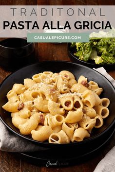 pasta alla grigia in a black bowl on a wooden table