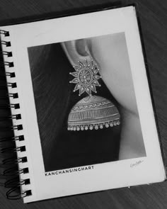 a black and white photo of a woman's hand with an intricate design on it