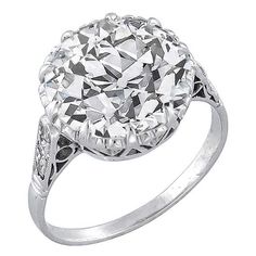 an antique style diamond ring on a white background