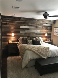 a bedroom with wood paneling on the wall and bed in it's center