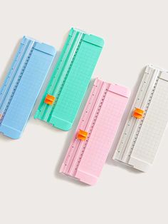 three different colored rulers laying next to each other