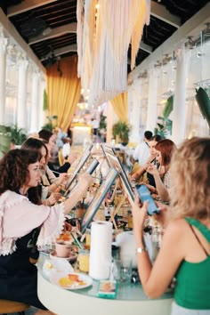 a group of people sitting around a table eating food