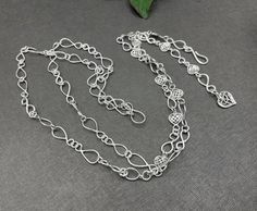 I made this sterling silver infinity and Celtic heart chain lariat belt which is perfect for a Renaissance wedding or cosplay event regal enough for a Queen!  It's a Y style girdle chain link belt handmade in 14 and 16 gauge sterling silver.  I fabricated every link by hand, soldered it all together for a waist measurement between 35-39 inches, with the drop down approximately 15 inches long.  It's a solid and meaty medieval style belt which will hold the test of time and look incredible to your Belt For Wedding Dress, Girdle Belt, Link Belt, Celtic Heart, Silver Belt, Medieval Style, Silver Belts, Silver Chain Style, Heart Chain