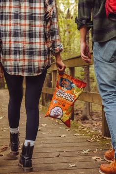 two people holding a bag of popcorn outside S'more Photoshoot, Evil Photoshoot, Popcorn Photoshoot, Cpg Photography, Canned Water, Popcorn Pumpkin, Product Photography Inspiration, Photoshoot Lifestyle, Camp Brand