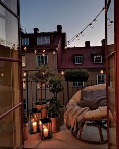 a balcony with lights and potted plants