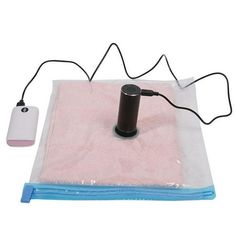 a pink towel with a black object on it and a cord connected to the device