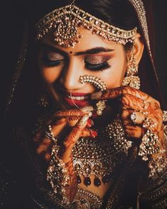 a woman with makeup and jewelry on her face