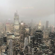 an aerial view of new york city with skyscrapers in the background and foggy sky