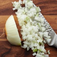 chopped onions on a cutting board next to a knife and cleaver with the end cut off