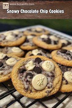 chocolate chip cookies with white icing and teddy bears on top are cooling on a rack