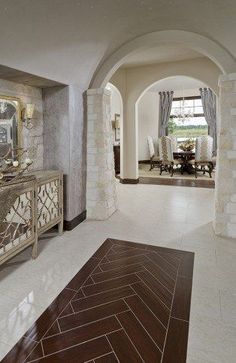 a large hallway with white walls and wood flooring