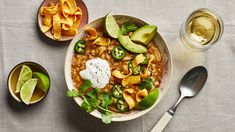 a bowl filled with beans, avocado and tortilla chips on top of a table